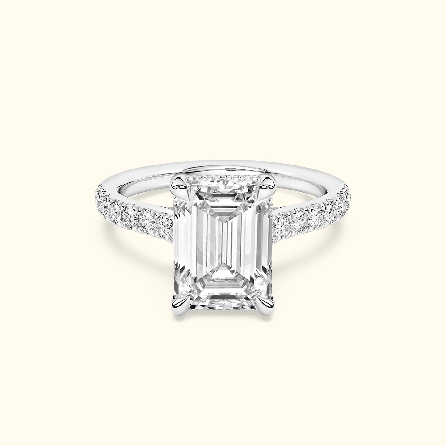 Emerald-cut diamond ring with a sparkling band, set against a light background.