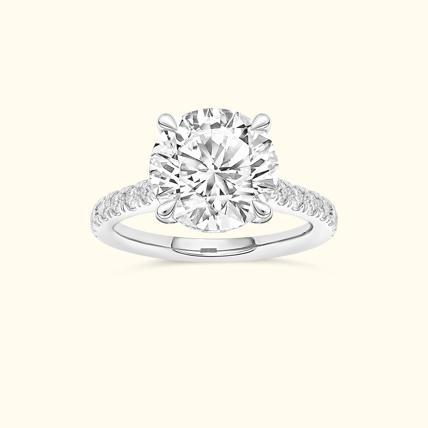 Elegant solitaire diamond ring with a round center stone and delicate band accents.