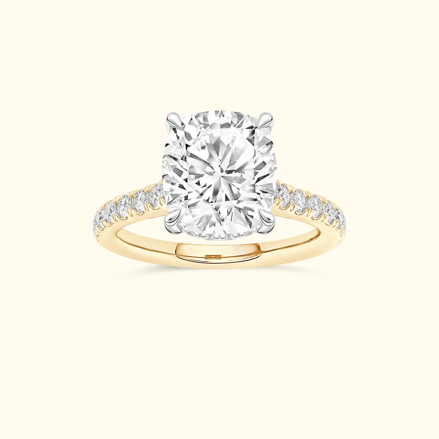 Cushion-cut diamond ring with a gold band and smaller diamonds along the sides.
