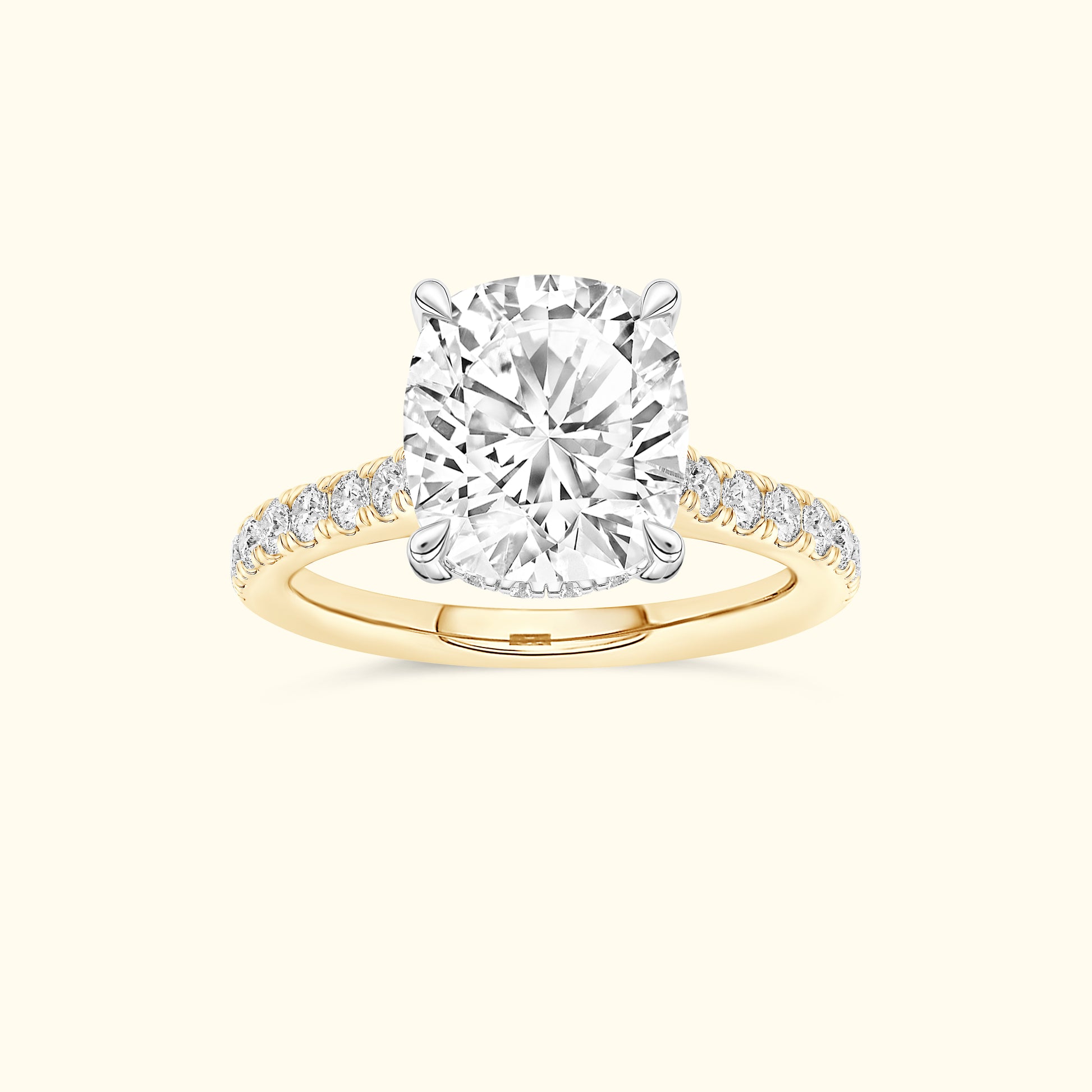 Cushion-cut diamond ring with a gold band and smaller diamonds along the sides.