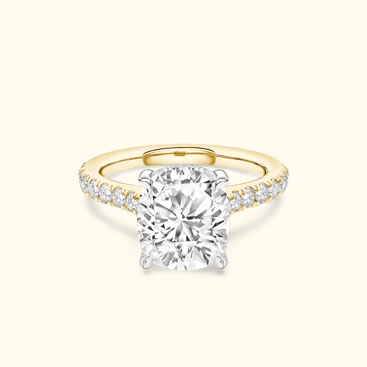 Cushion-cut diamond ring with a yellow gold band and sparkling side stones.