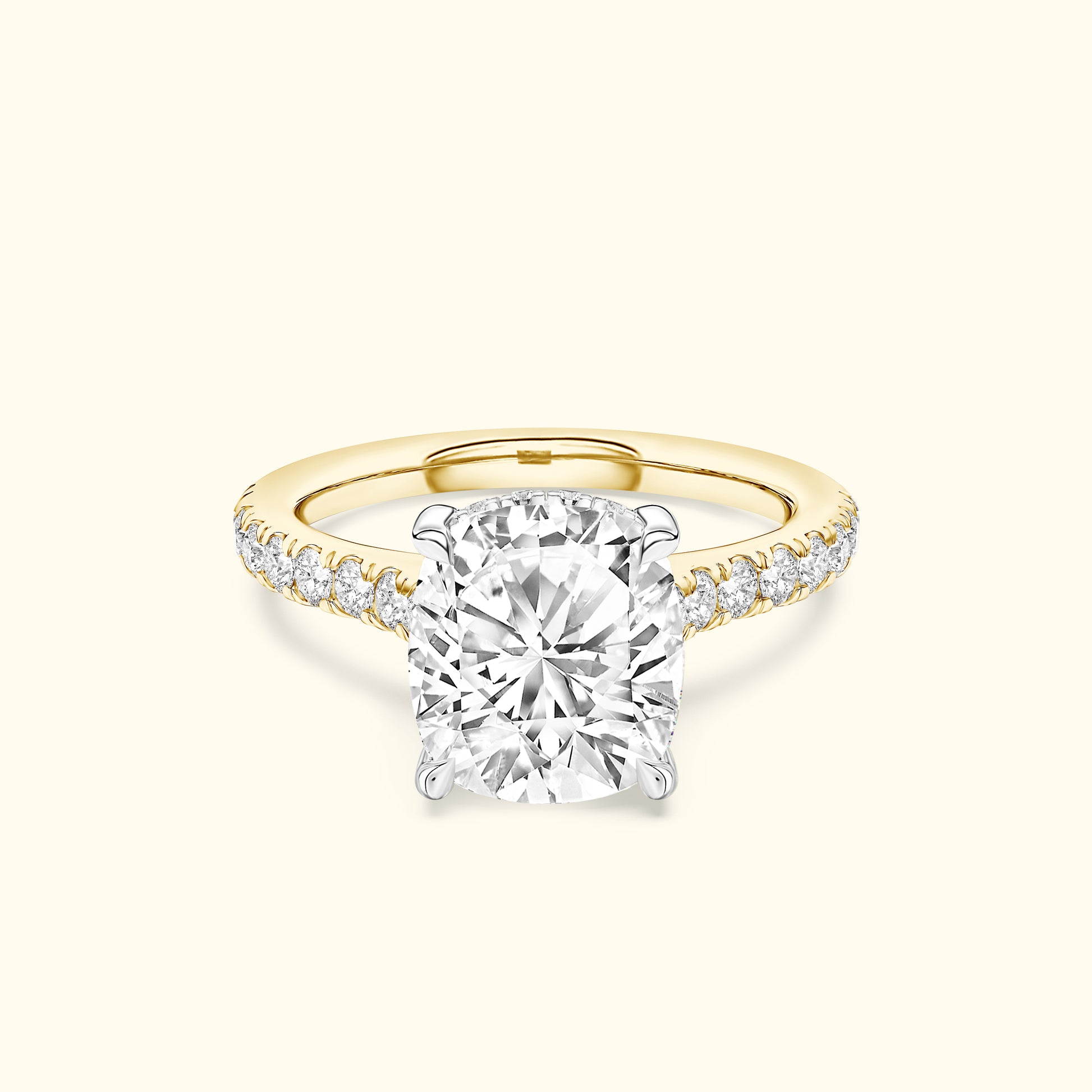Cushion-cut diamond ring with a yellow gold band and sparkling side stones.