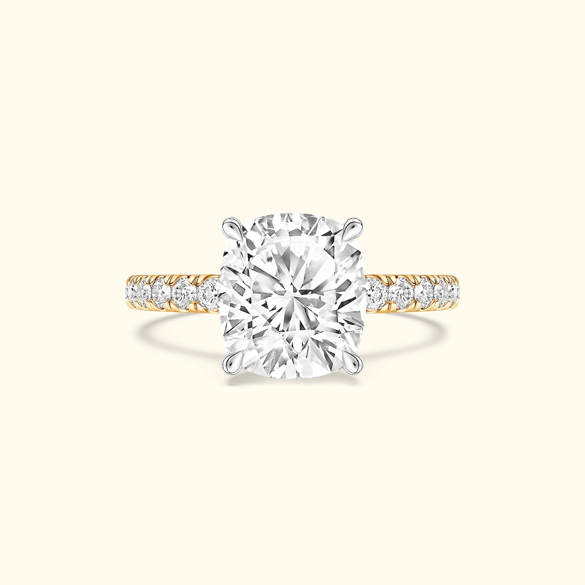 Cushion-cut diamond ring with a gold band and smaller diamonds along the shank.