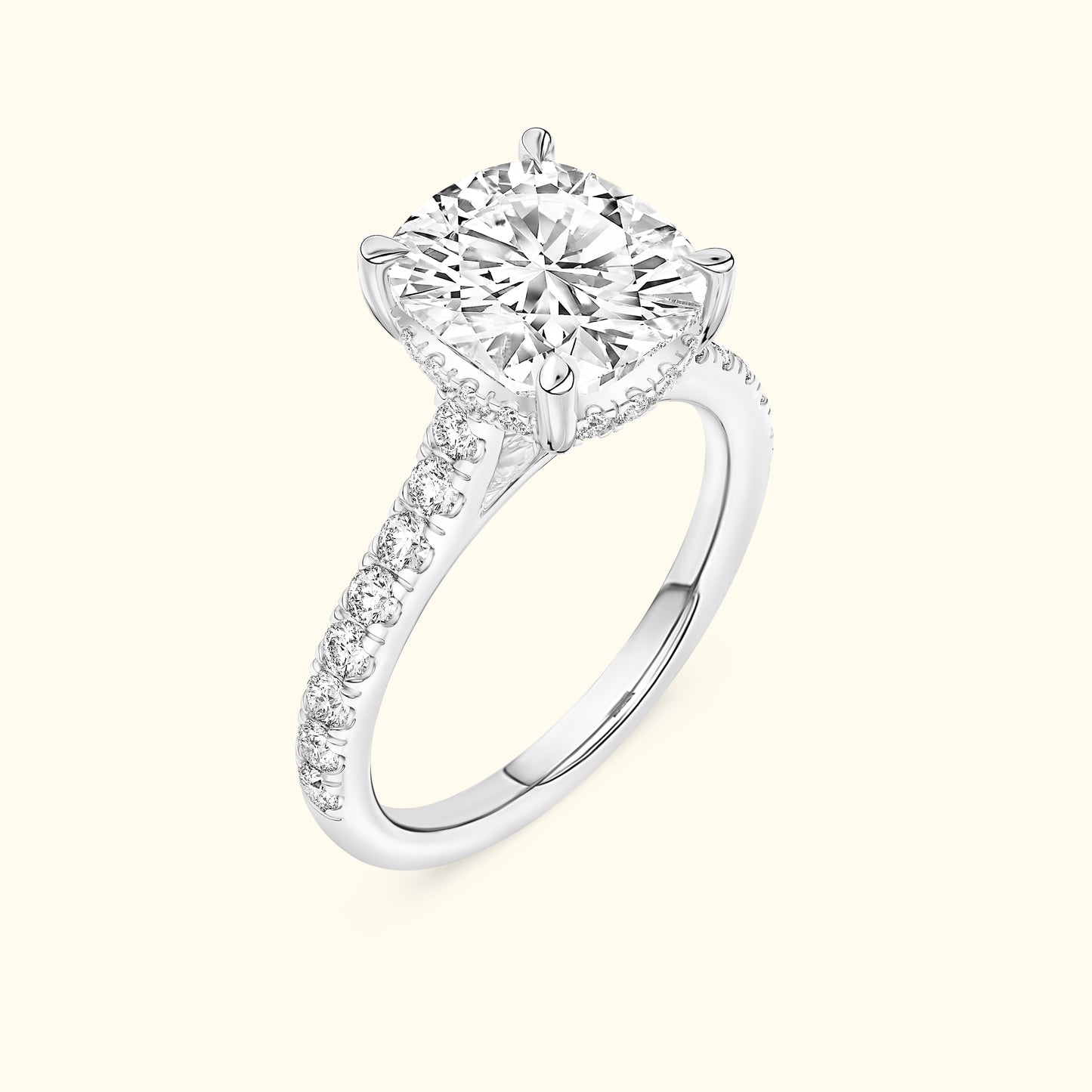 Solitaire diamond engagement ring with a halo setting and pave band in white gold.