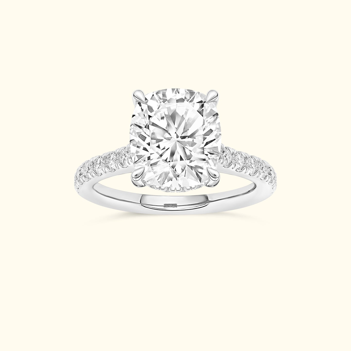 Cushion-cut diamond ring set in a white gold band, adorned with smaller diamonds.