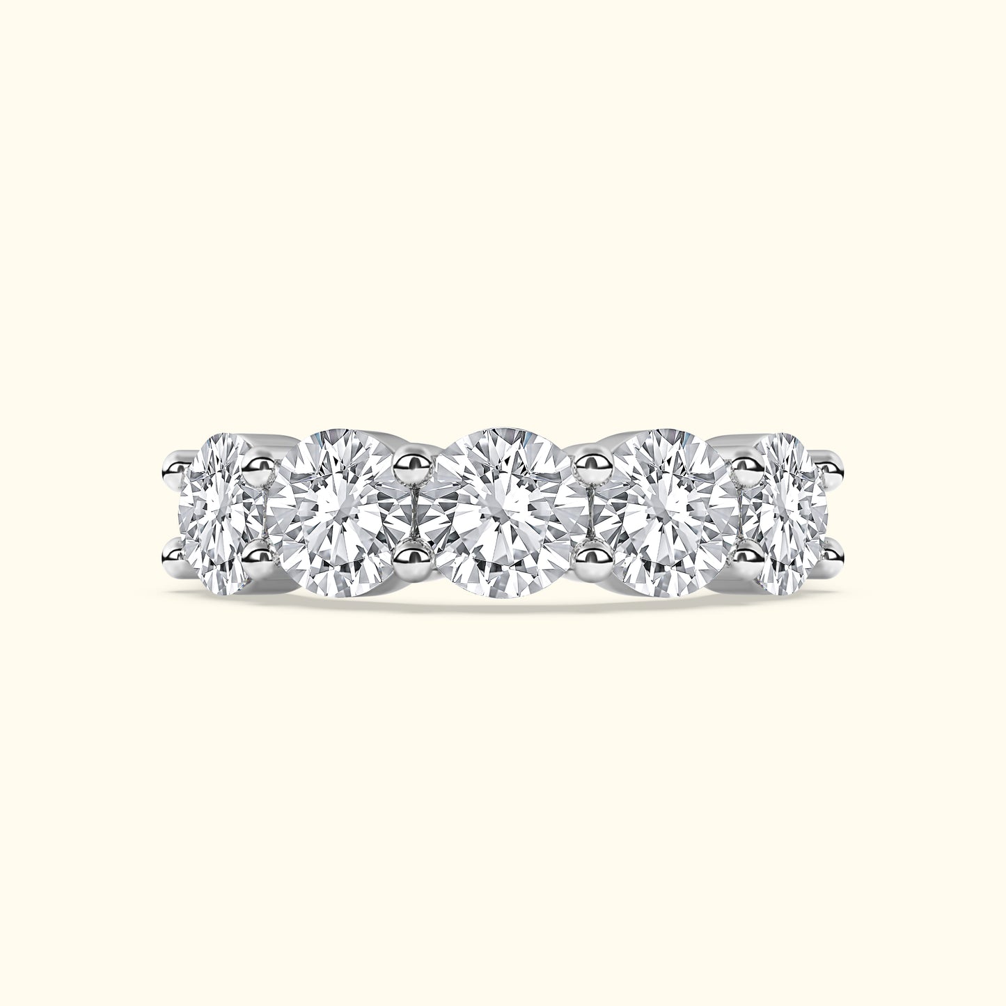 Five round diamonds set in a sleek white gold band with a polished finish.