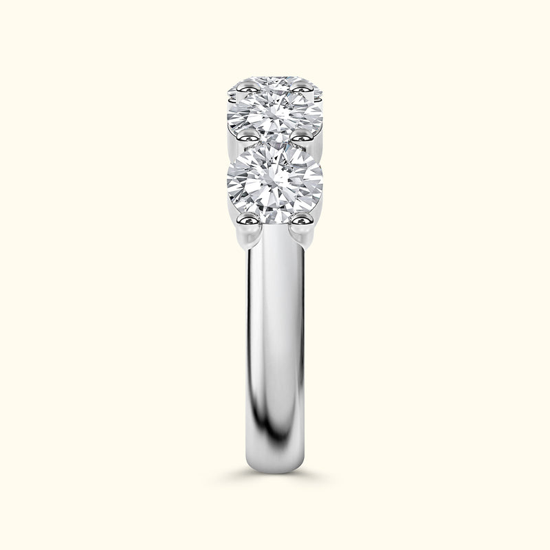 Three-stone diamond ring with a polished white gold band.