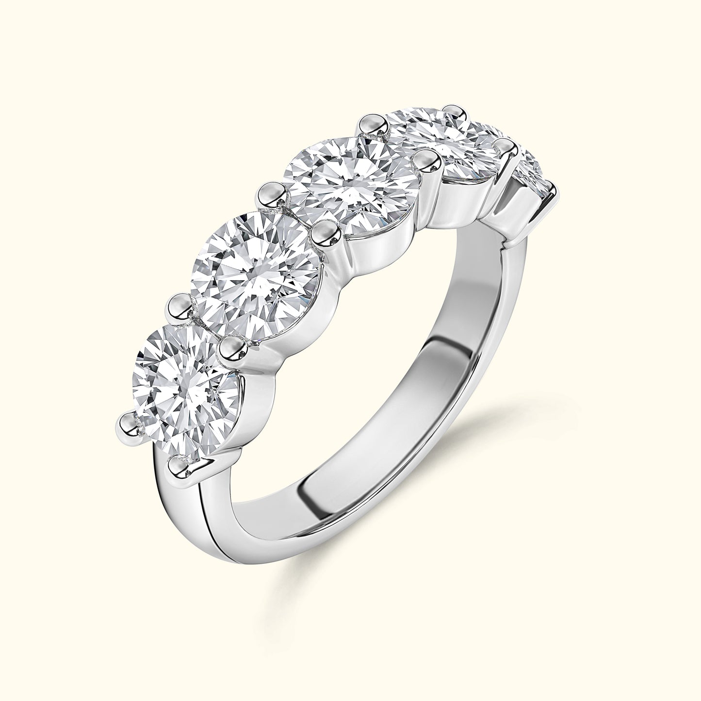 Five-stone diamond ring with a polished silver band, showcasing brilliant round diamonds.