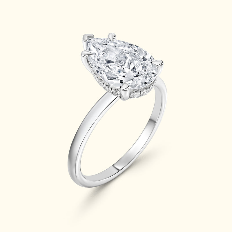 Elegant pear-shaped diamond engagement ring atop a polished white gold band.
