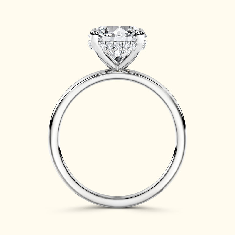 Elegant solitaire engagement ring with a large round diamond and smaller accent stones.