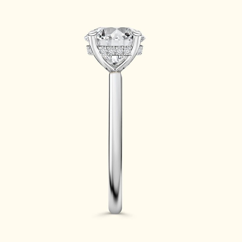 Solitaire diamond engagement ring with a sleek silver band and intricate detailing.