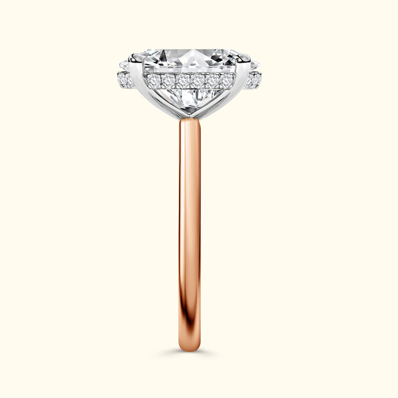 Engagement ring featuring a large diamond and a rose gold band, accented with smaller stones.