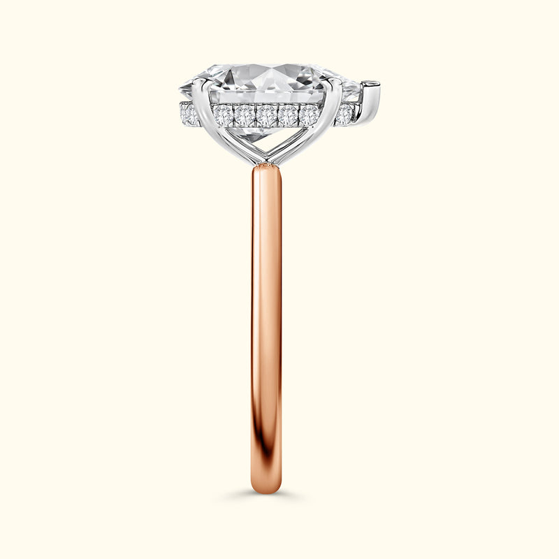 Rose gold and silver ring featuring a large diamond with smaller stones on the band.