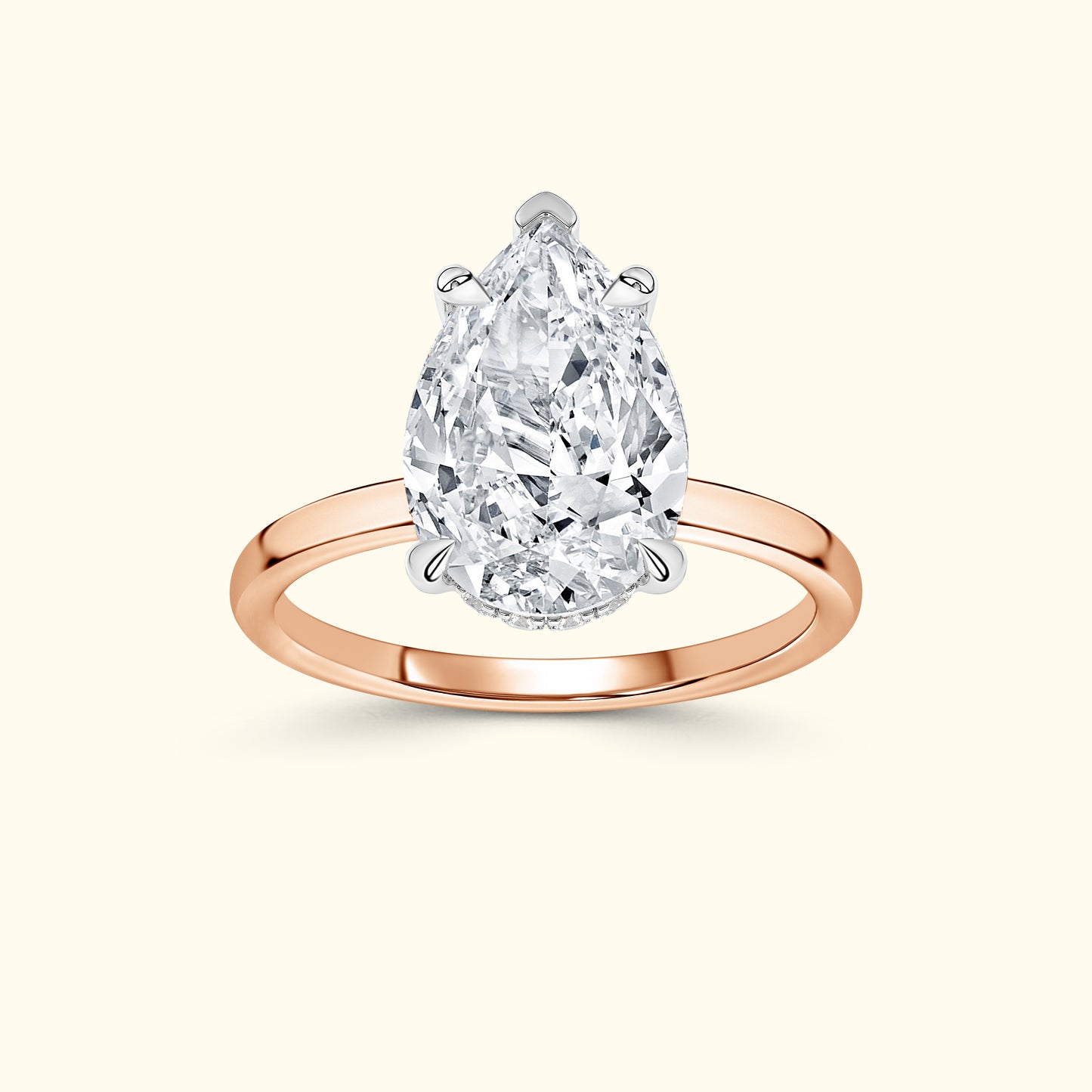 Pear-shaped diamond engagement ring with a rose gold band.