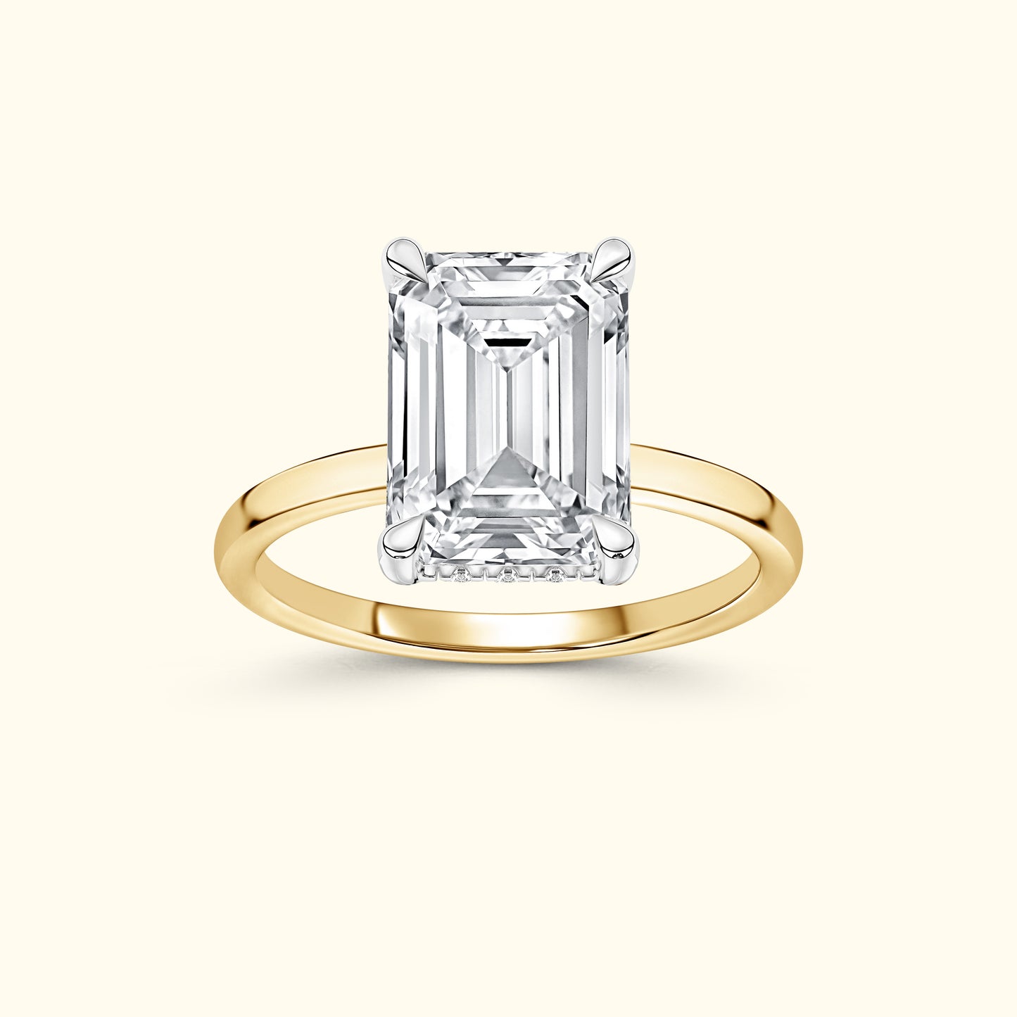 Emerald-cut diamond ring on a simple yellow gold band, elegant and refined.