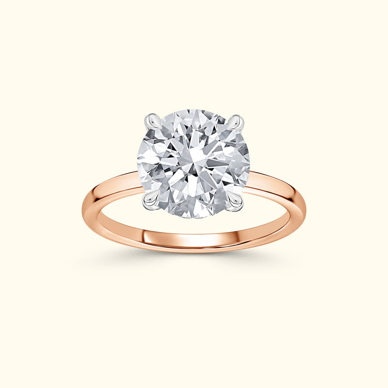 Rose gold ring featuring a large round diamond set in a four-prong setting.