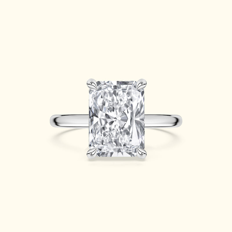 Elegant silver ring featuring a large, clear rectangular diamond.