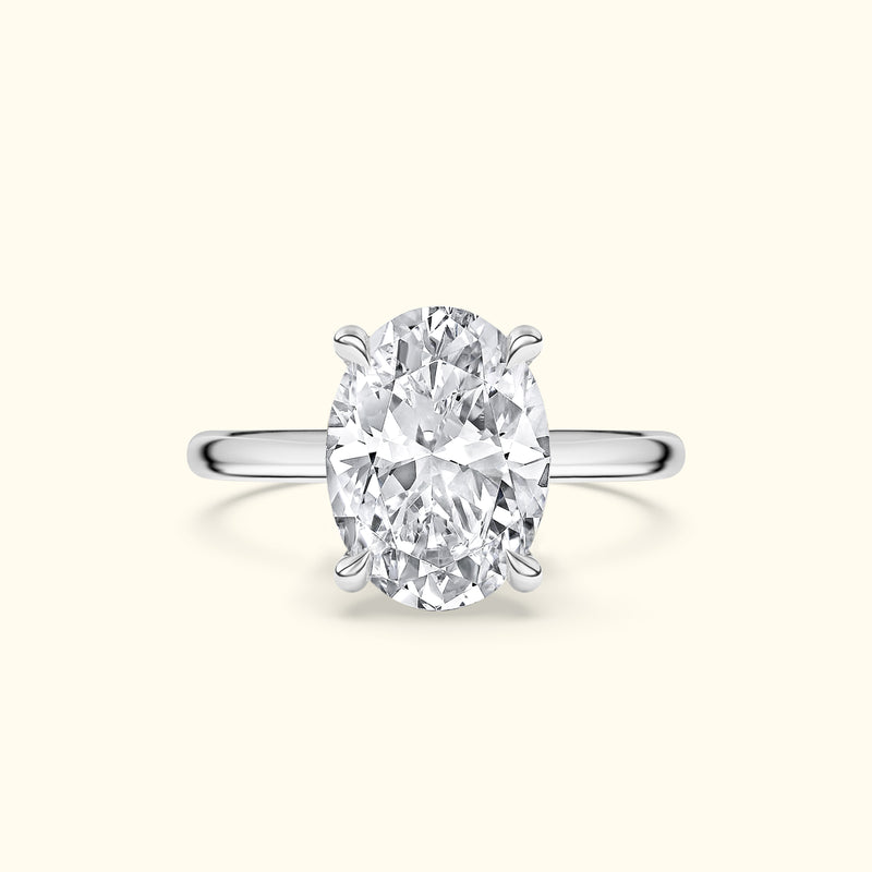 Oval diamond engagement ring with a sleek silver band.