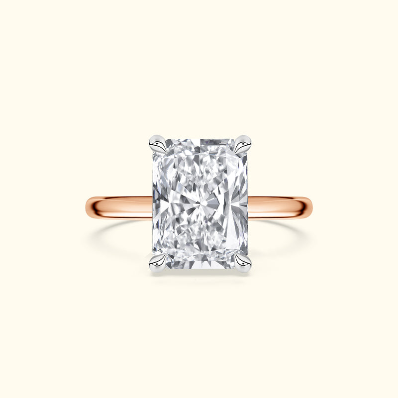 Elegant rectangular diamond ring with a rose gold band.