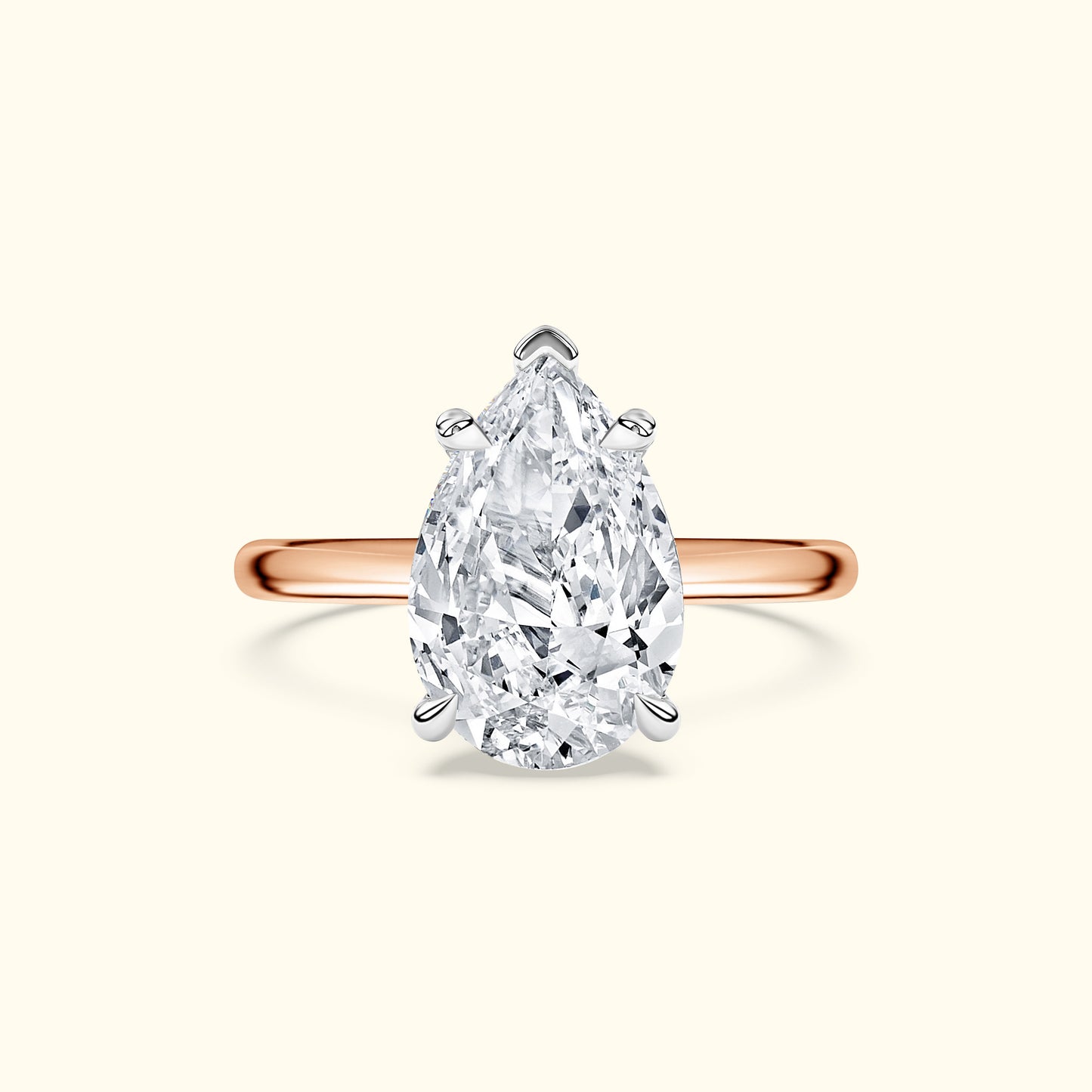 Teardrop-shaped diamond ring with a rose gold band.