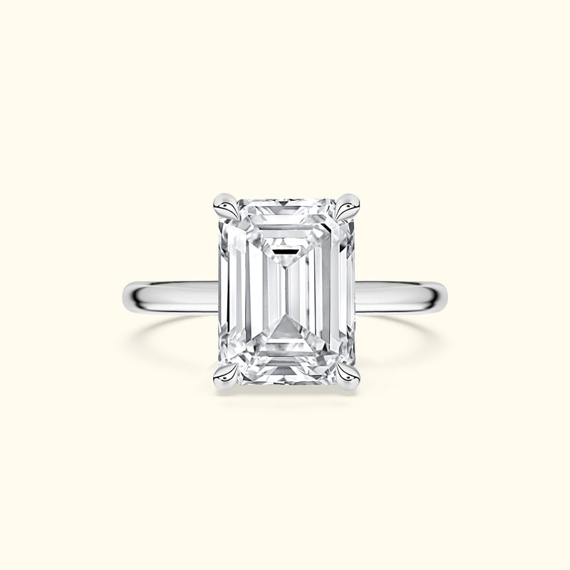 Elegant white gold ring featuring a large emerald-cut diamond.