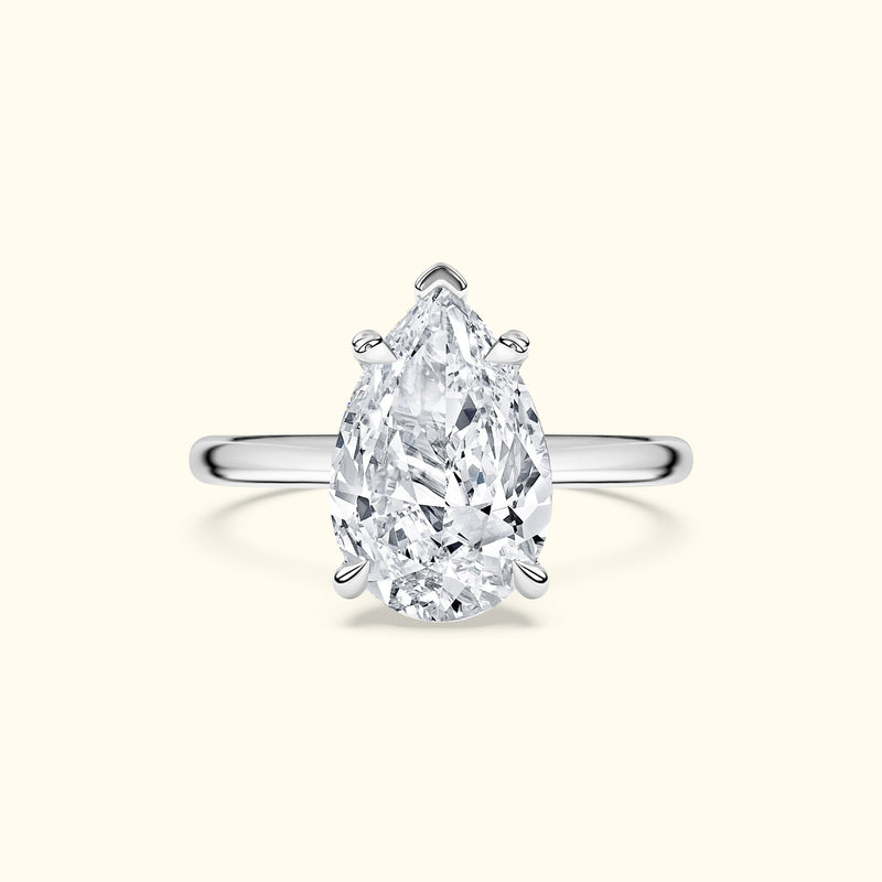 Teardrop-shaped diamond ring set in a polished silver band.