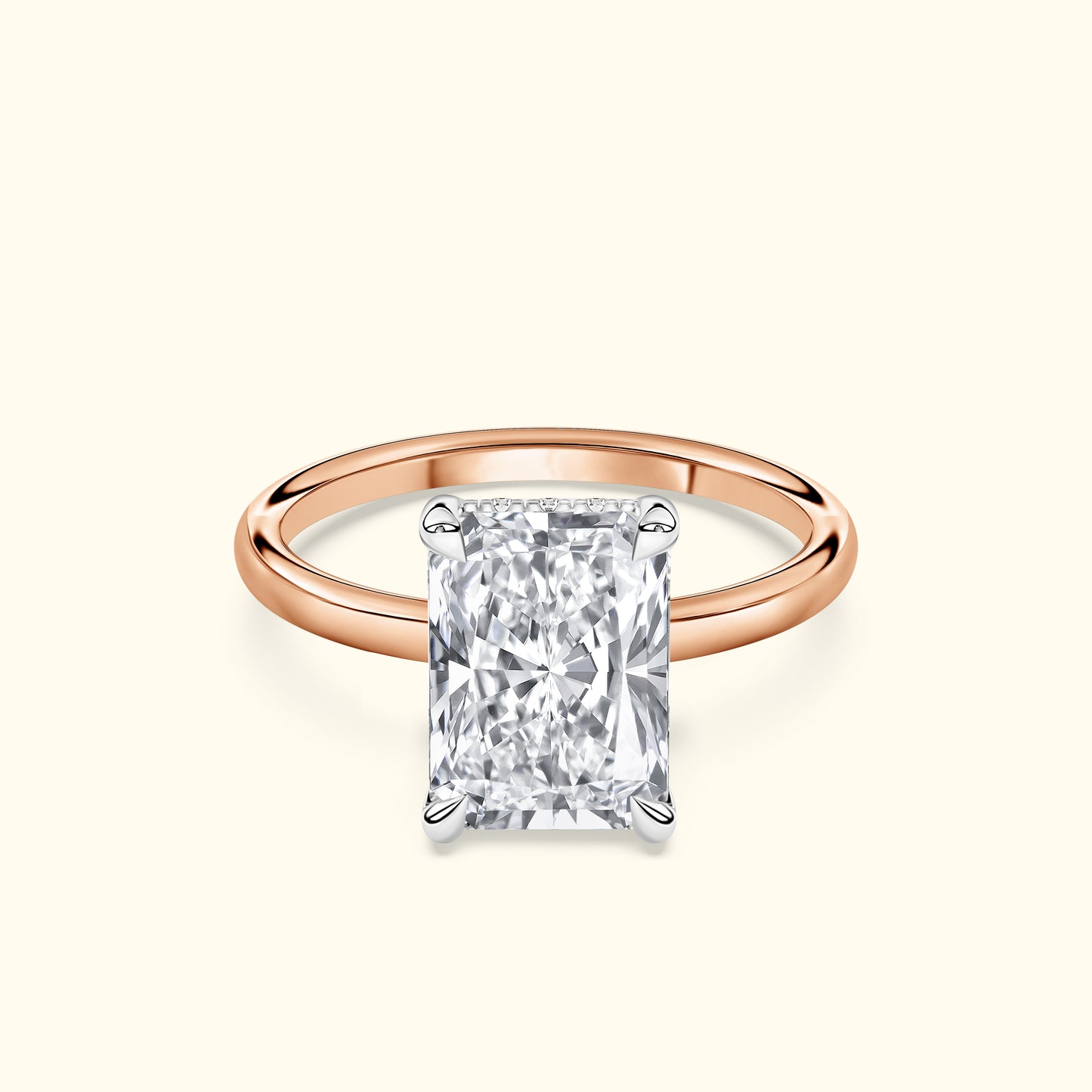 A rose gold ring featuring a large, rectangular diamond in a four-prong setting.