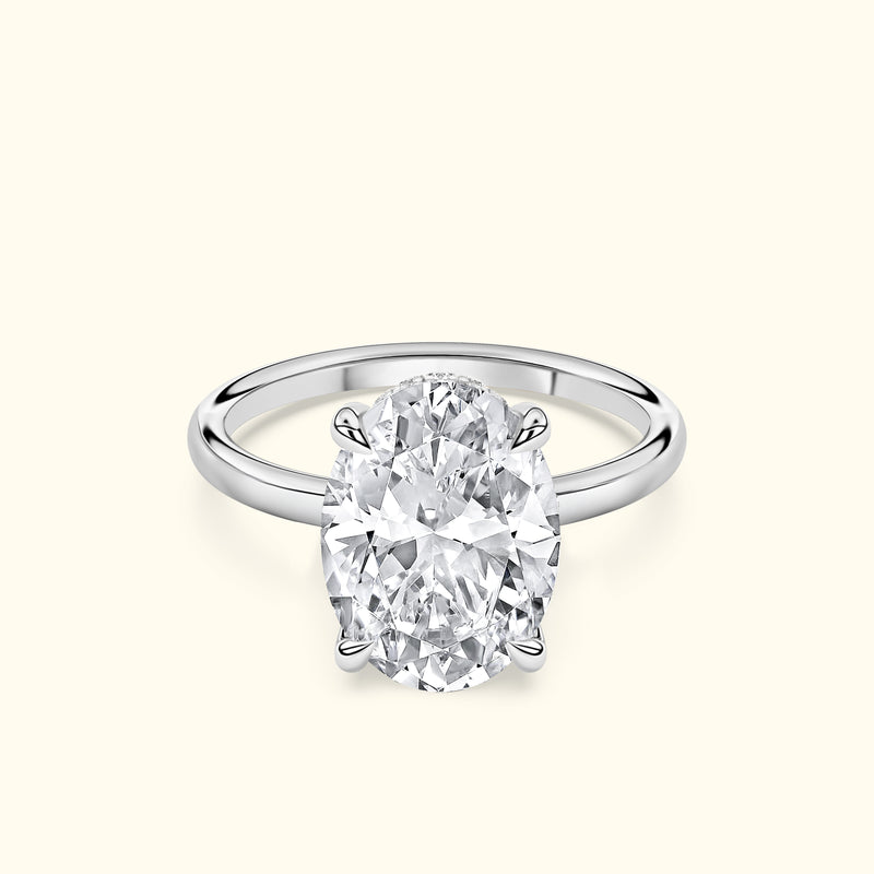 Elegant silver ring featuring a large oval diamond at the center.