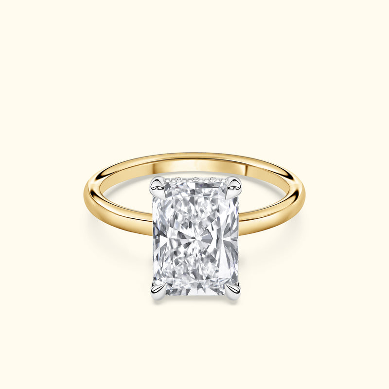 Classic gold ring featuring a large rectangular diamond center stone.