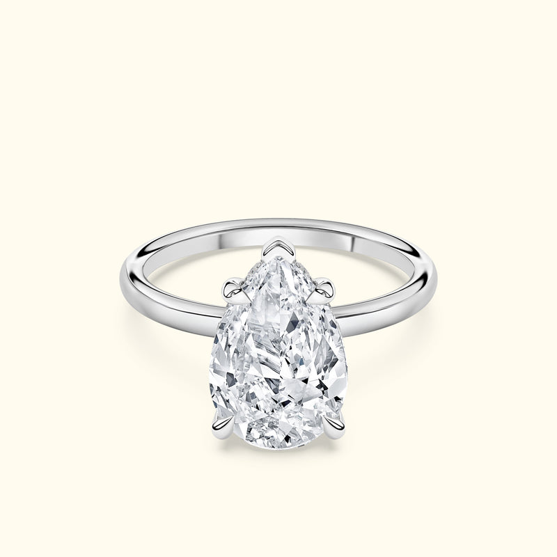 Elegant pear-shaped diamond ring set in a sleek silver band.