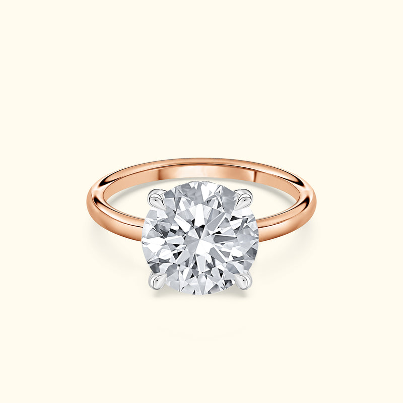 Solitaire engagement ring featuring a large round diamond on a rose gold band.