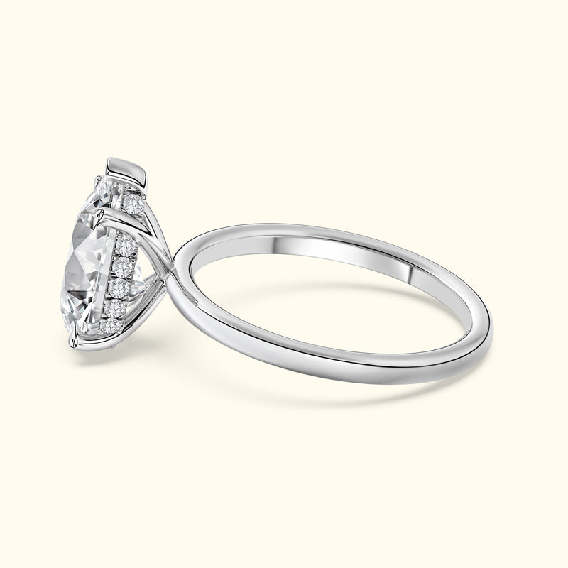 Elegant silver engagement ring with a large diamond and smaller accent stones.