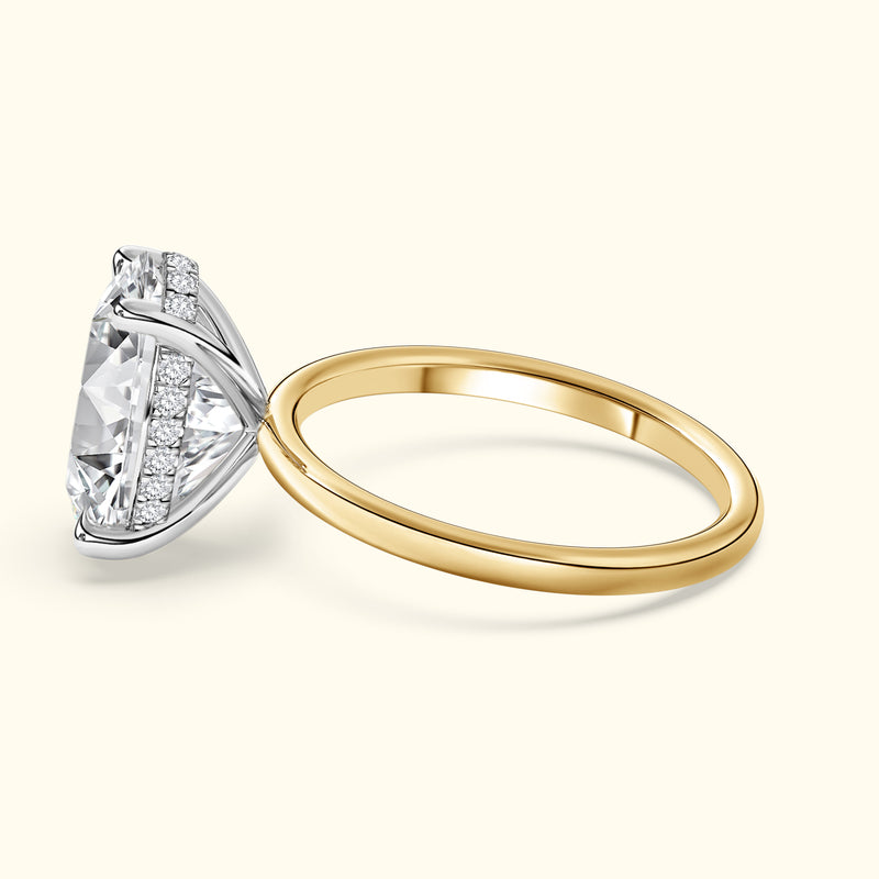 Elegant two-tone engagement ring featuring a large diamond and smaller side stones.
