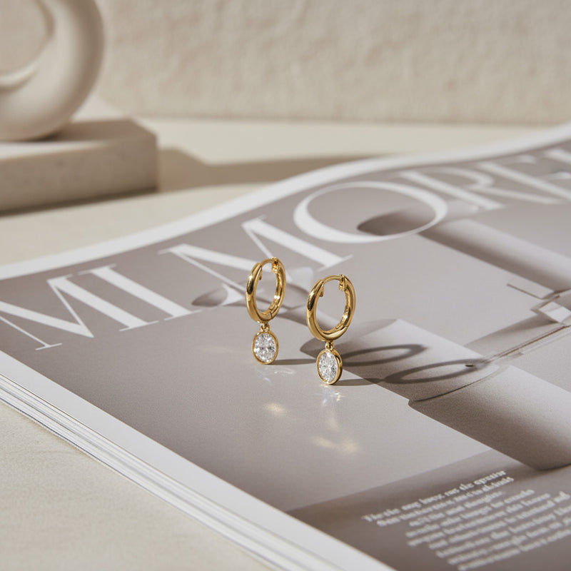 Yellow gold Huggie with a Bezel Set Oval Diamond Drop