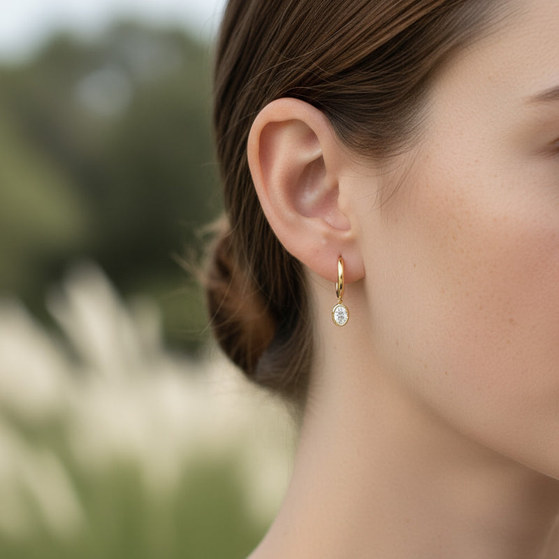 Yellow gold Huggie with a Bezel Set Oval Diamond Drop