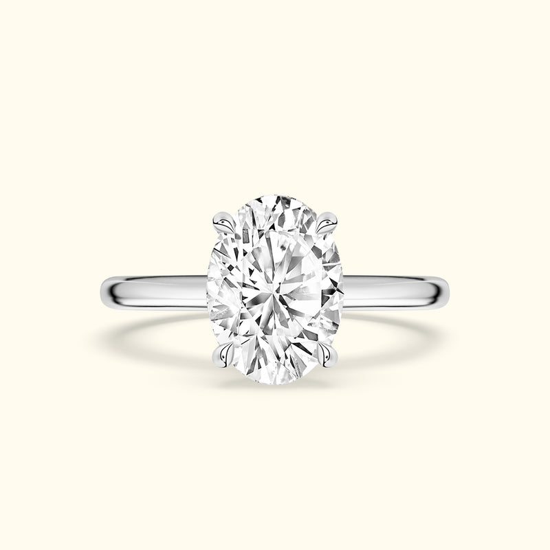 Sleek silver ring featuring a large oval diamond center stone.