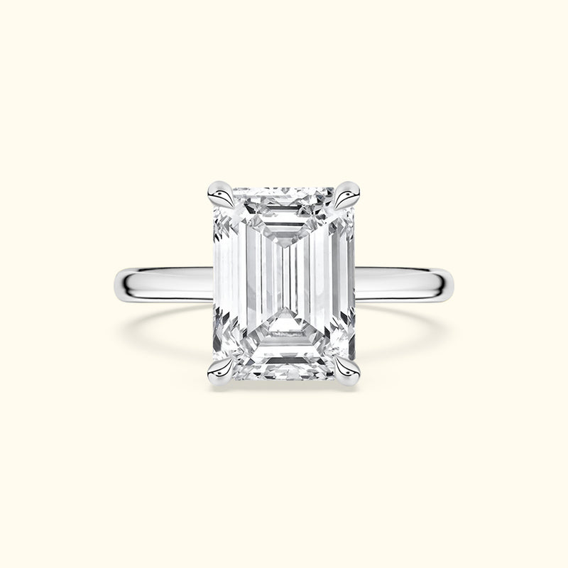 Emerald-cut diamond ring with a sleek silver band.