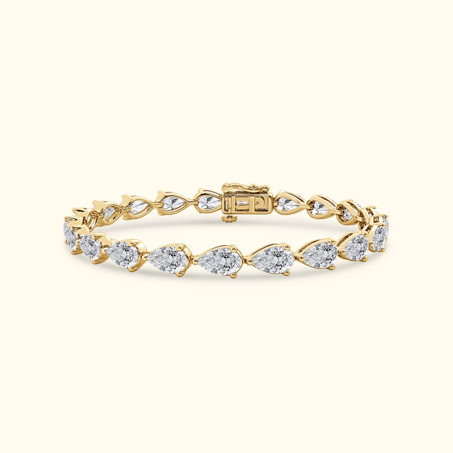 Gold bracelet featuring pear-shaped diamonds in a linked design.
