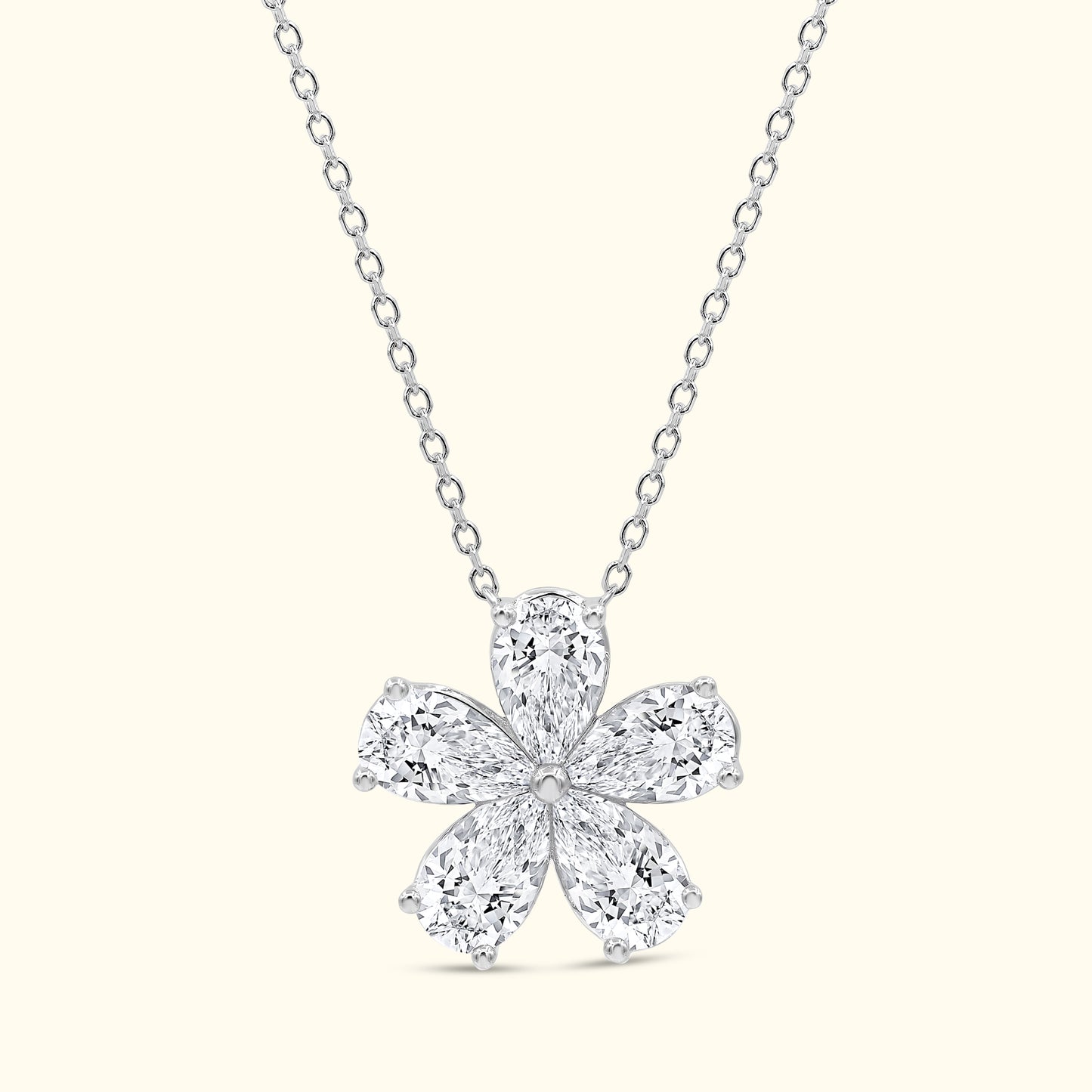 Elegant diamond flower pendant on a delicate silver chain.