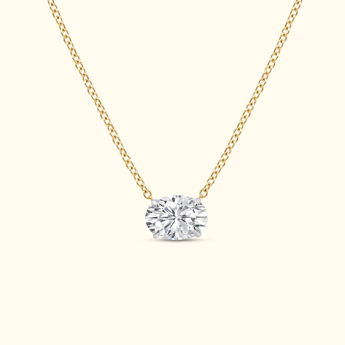 Gold chain necklace featuring a large oval diamond pendant.