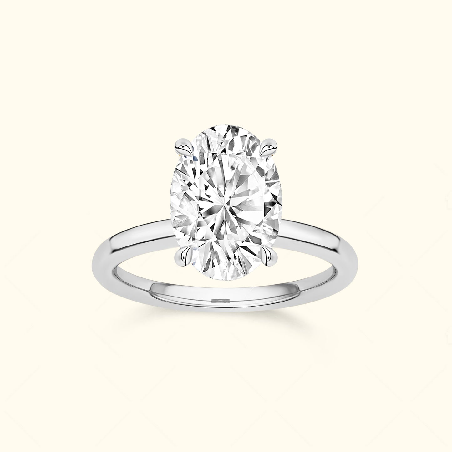 Oval diamond engagement ring set in a simple silver band.