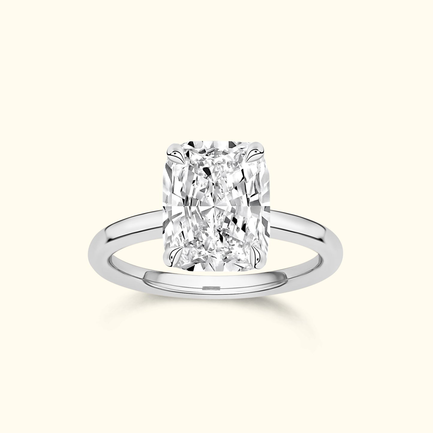 A sparkling rectangular diamond ring with a sleek silver band.