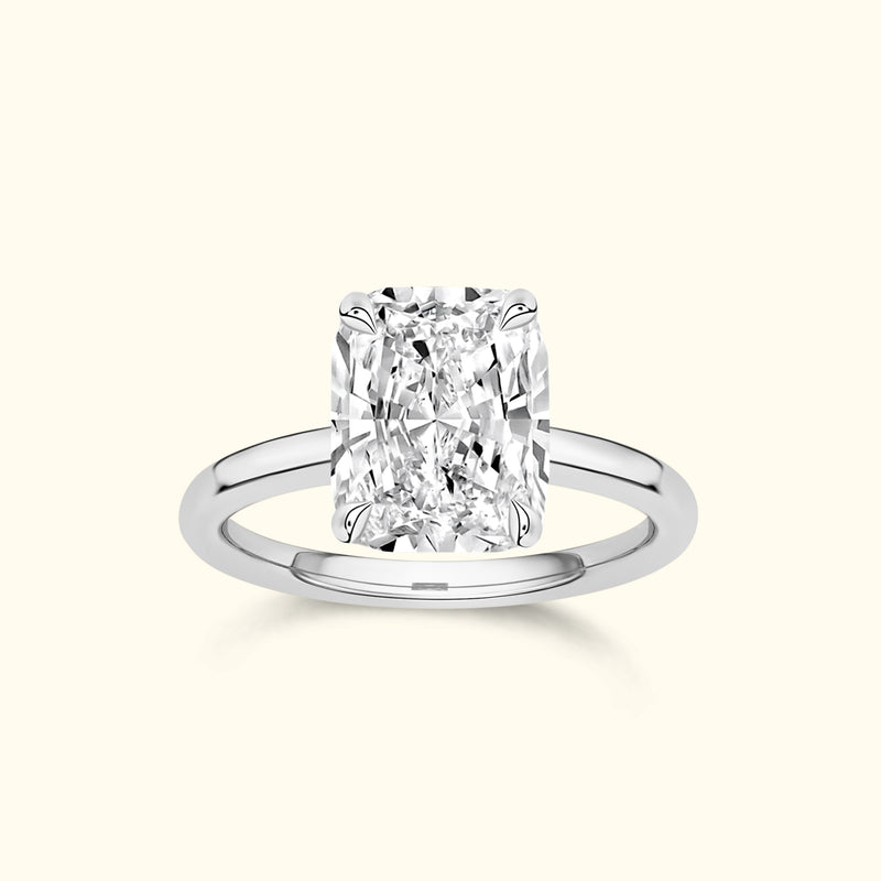 A sparkling rectangular diamond ring with a sleek silver band.