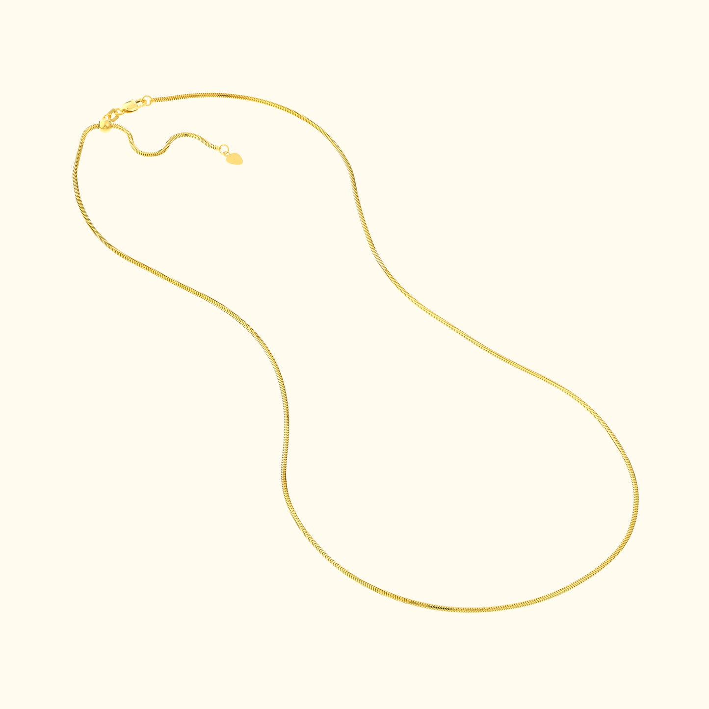 Smooth gold chain necklace with a delicate clasp, elegantly shaped and laid out flat.