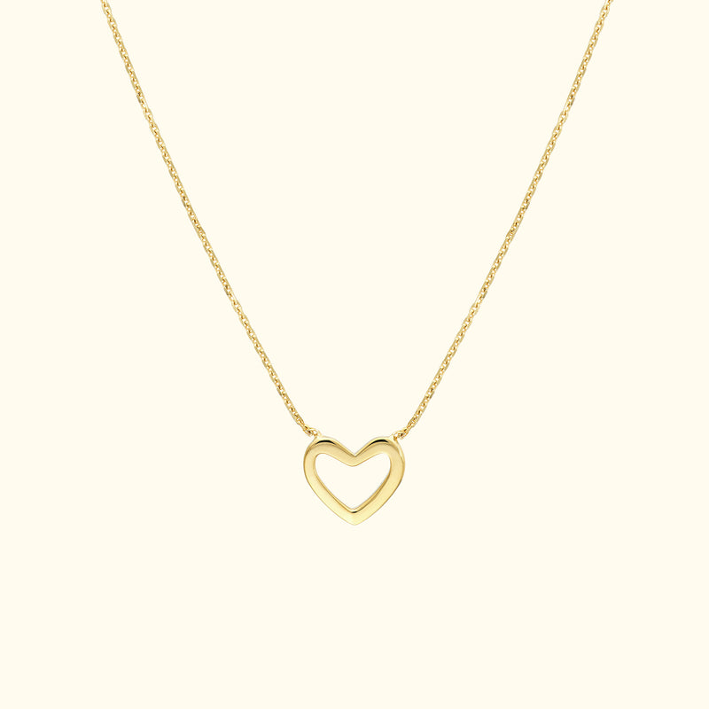 Gold heart-shaped pendant necklace on a delicate chain.