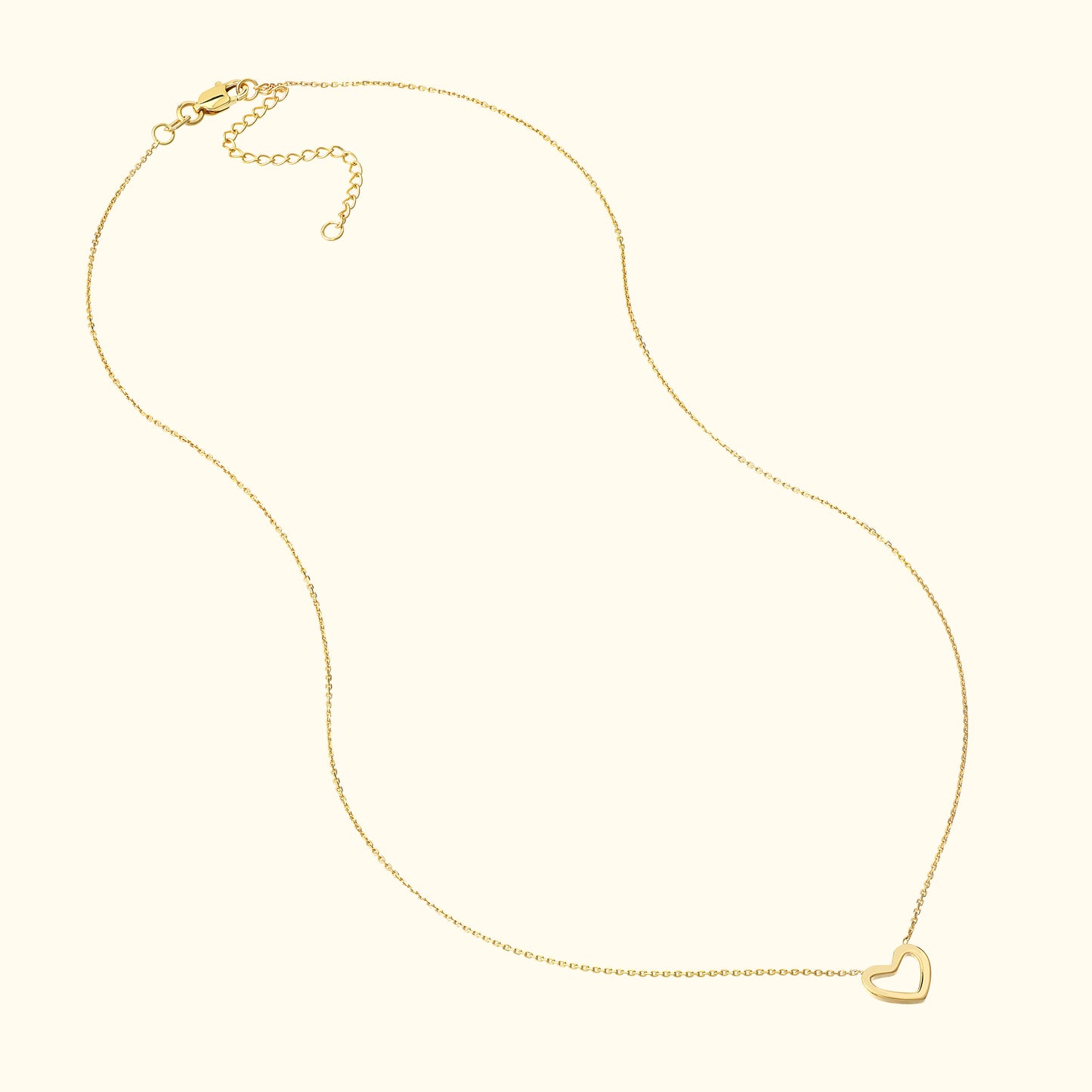 Delicate gold necklace with a small heart pendant.