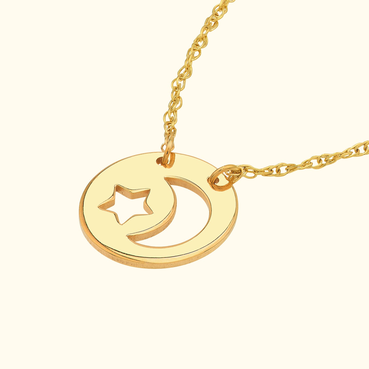 Gold necklace featuring a circular pendant with a star and crescent moon design.
