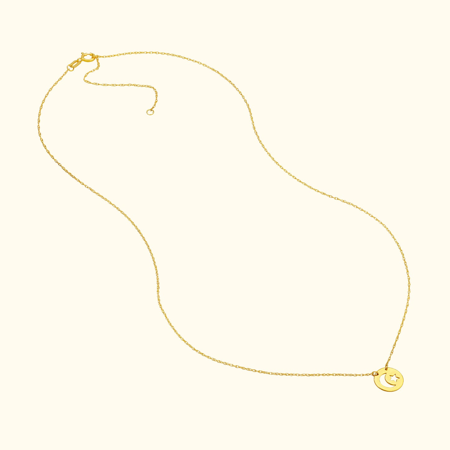 Delicate gold necklace with a smiling moon pendant on a soft, neutral background.