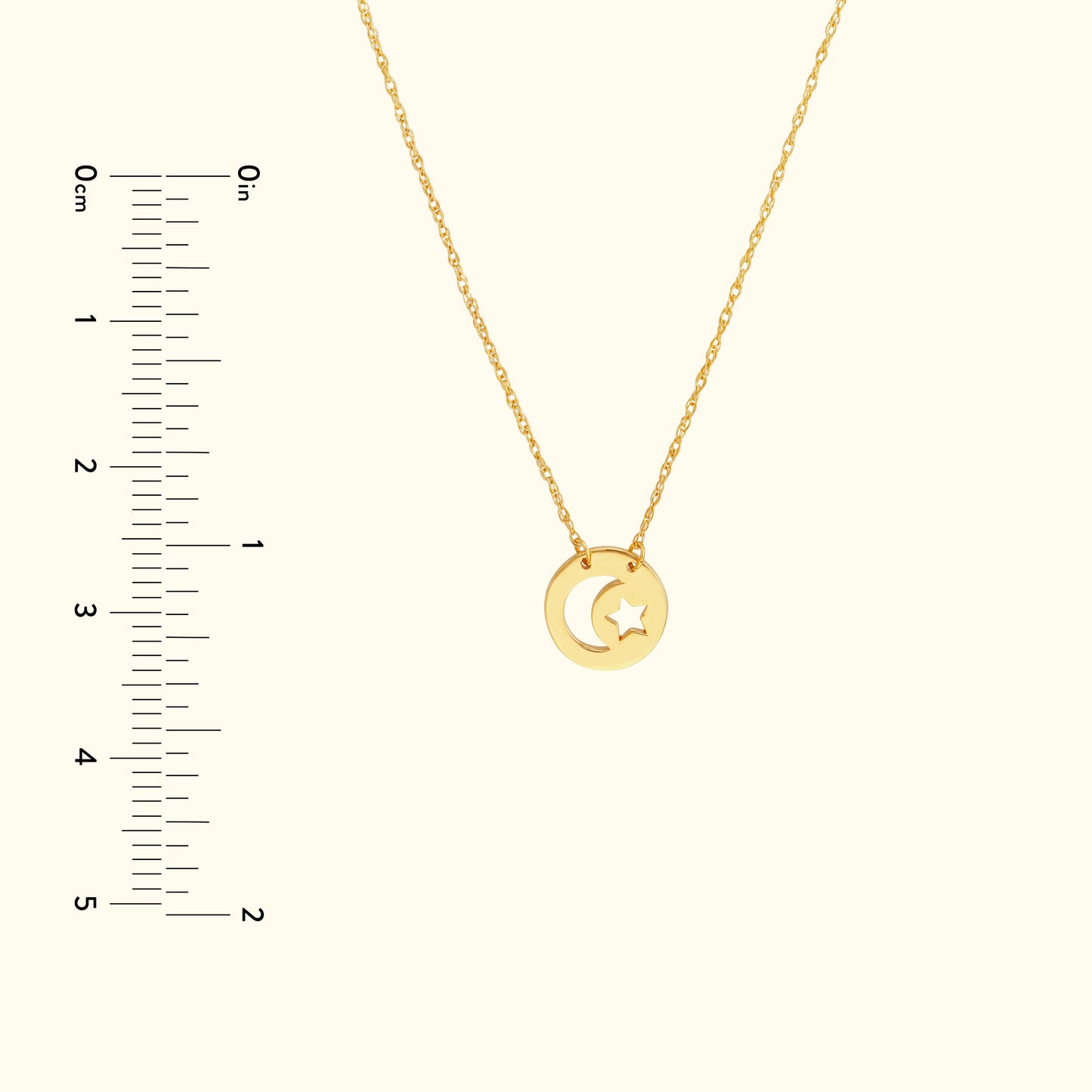 Gold necklace featuring a crescent moon and star pendant against a neutral background.