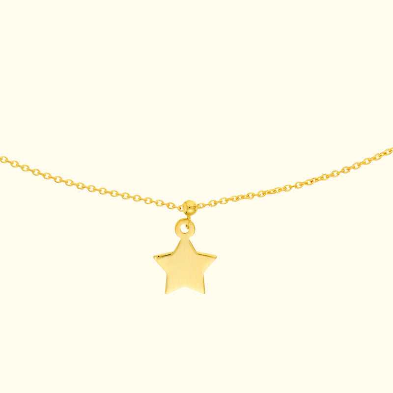 Gold necklace featuring a small star pendant on a delicate chain.
